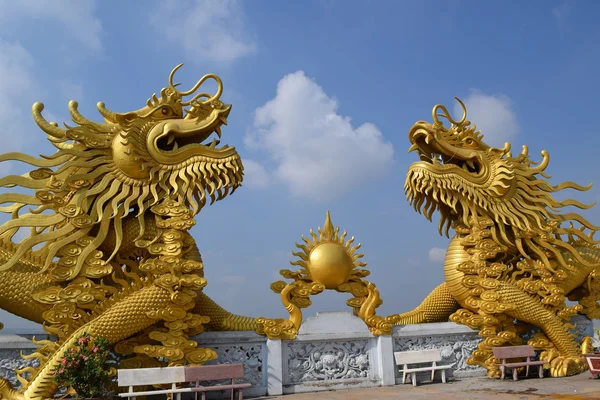 Two big statue of golden dragon at Buddhist Chau Thoi temple, vietnam