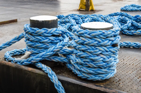 Blue Rope Tied to a Bollard with a Knot