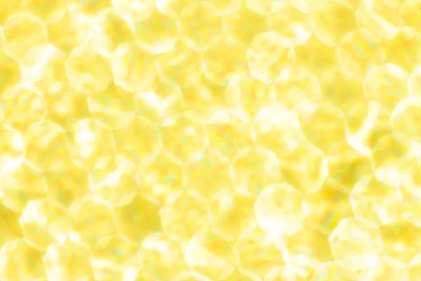 Metallic Gold yellow Lights Festive background. Abstract Christmas twinkled bright background with bokeh defocused silver lights