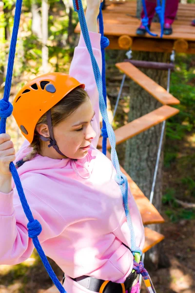 Girl climbs into ropes course