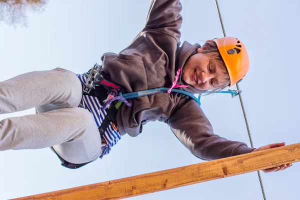Girl climbs into ropes course