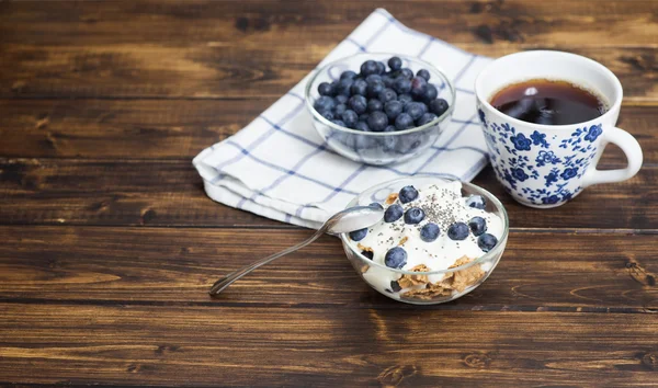 Fitness wheat muesli with yogurt, blackberry and tea