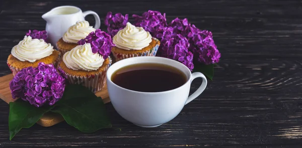 Cupcakes with cream, coffee and flowers