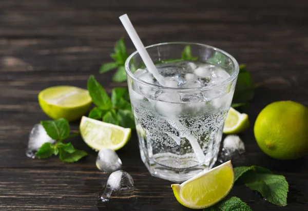 Cocktail with soda water, ice, lime and mint
