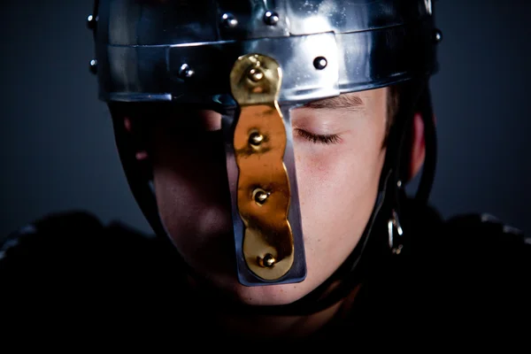 Young Boy Wearing Roman Soldier Helmet