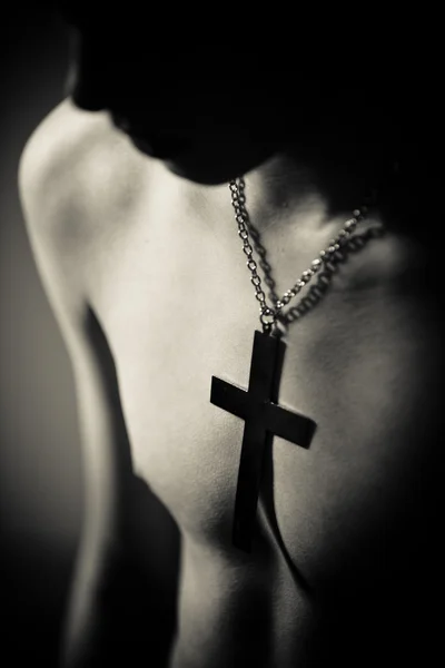 Teenage Boy Wearing Cross on Chain Around Neck