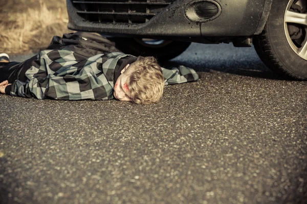 Teen Boy Car Accident Victim Lying on Road by Car