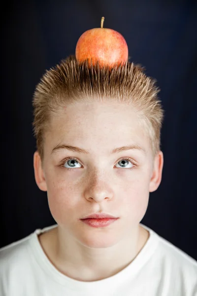 Preteen Boy Balancing Apple on Top of Head