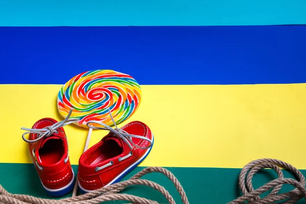 Small red boat shoes and lollipop