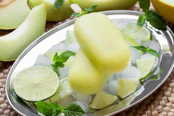 Melon and lime sorbet ice cream popsicles.
