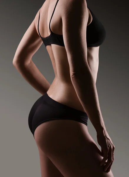 Female sexy body in black underwear.  Woman body care.
