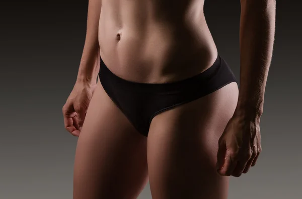 Female sexy body in black underwear.  Woman body care.