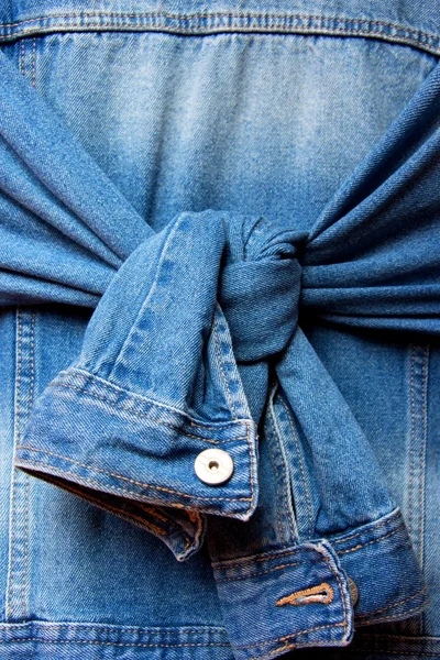 Blue denim jacket with knot tied sleeves