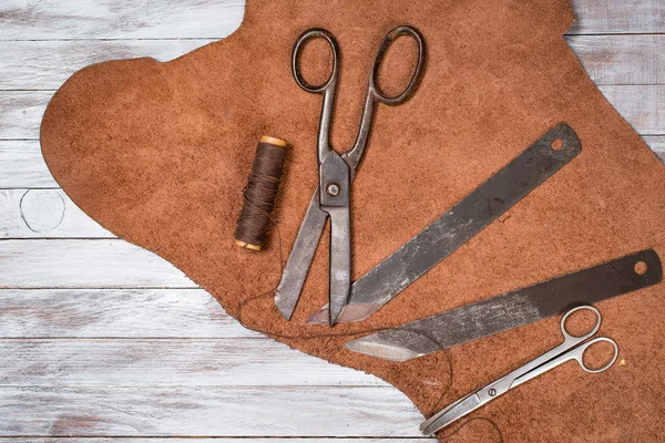 A lot of work tools and leather for shoemaker.Leather craft. Copy space.