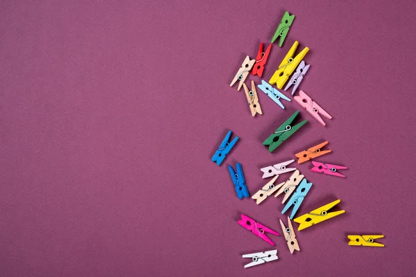 A lot of colorful clothes pegs for scrapbooking, design or decor.