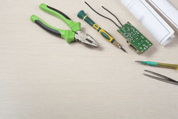 Set of electrical tool on wooden background. Accessories for engineering work, energy concept.