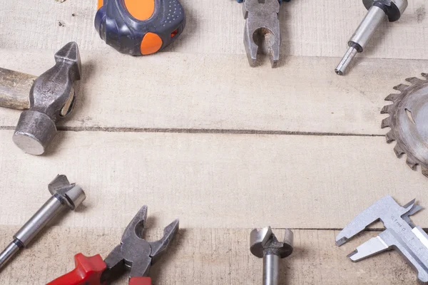 Construction tools on wooden background. Copy space for text. Set of assorted work tool at wood table . Top view