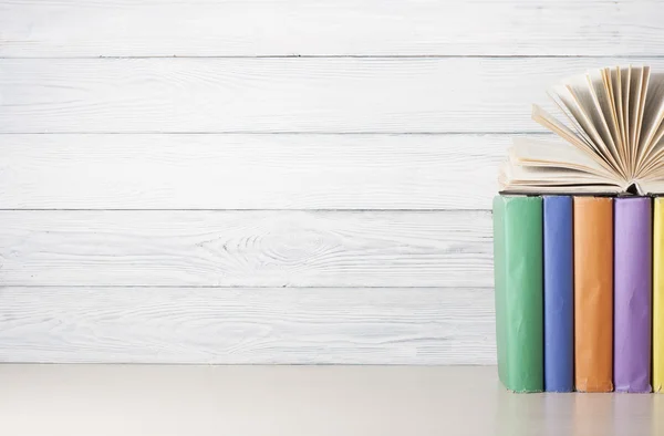 Open book, hardback books on wooden table. Education background. Back to school. Copy space for text.