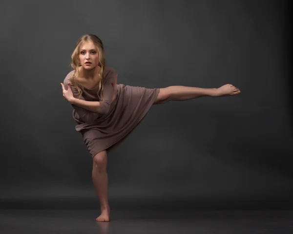 Dancer. Contemporary dance. Beautiful elegant woman dances on gray background