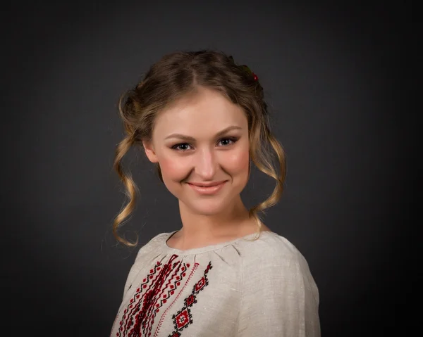 Beautiful happy cute young woman in Ukrainian embroidery