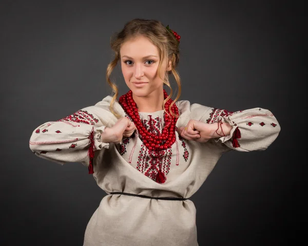 Beautiful happy cute young woman in Ukrainian embroidery dancing