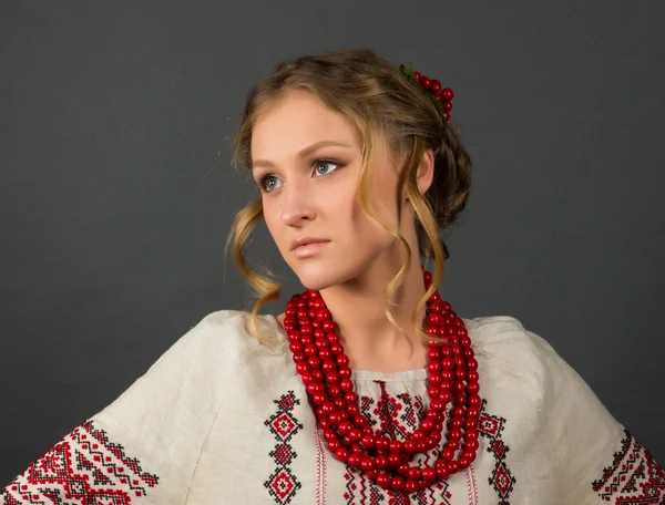 Beautiful serious young woman in Ukrainian embroidery