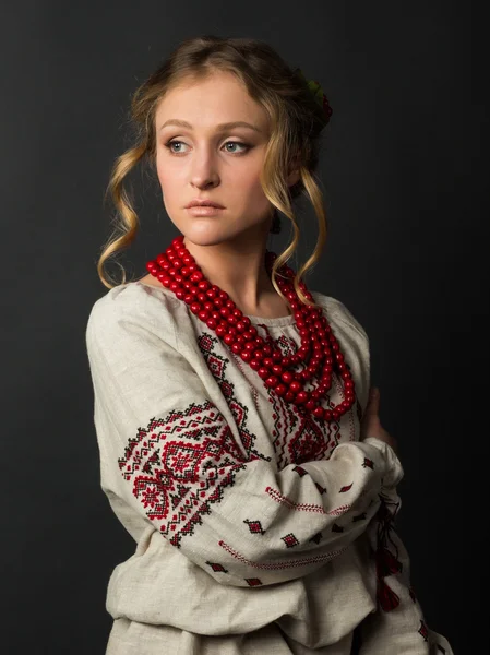 Beautiful serious young woman in Ukrainian embroidery