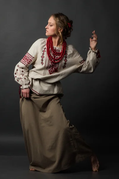 Dancer. Beautiful happy cute young woman in Ukrainian embroidery dancing