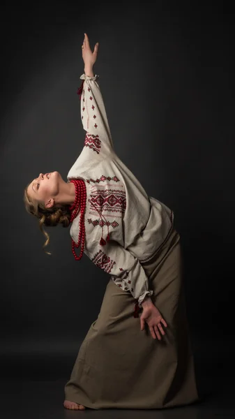 Dancer. Beautiful happy cute young woman in Ukrainian embroidery dancing