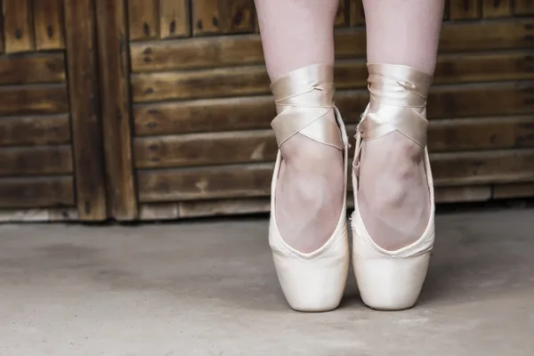 Feet dressed in dance pointe shoes