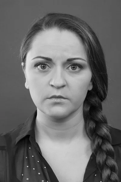 Upset serious girl on a gray background. Black and White Photo
