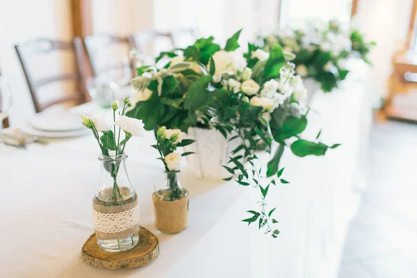 Wedding centerpiece and decorated bottle with flower