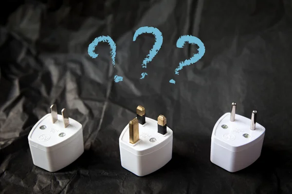 Choosing from various electric plug adapters. Difficulties and problems of traveling around the world. Black and white