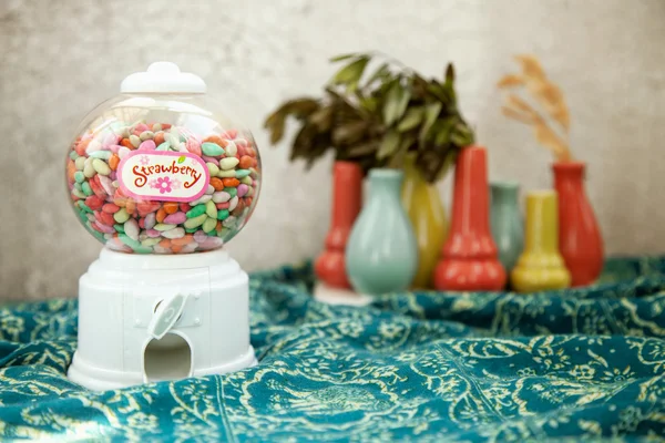 Round transparent bubble vending candy machine toy on a colorful background. Vintage warm  colors