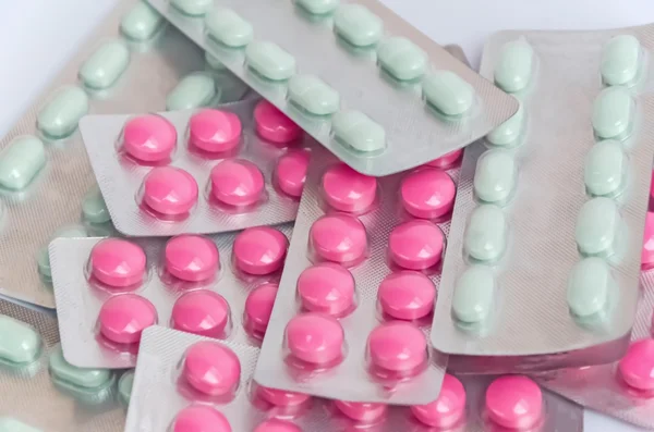 Light green & pink medicine in foil package