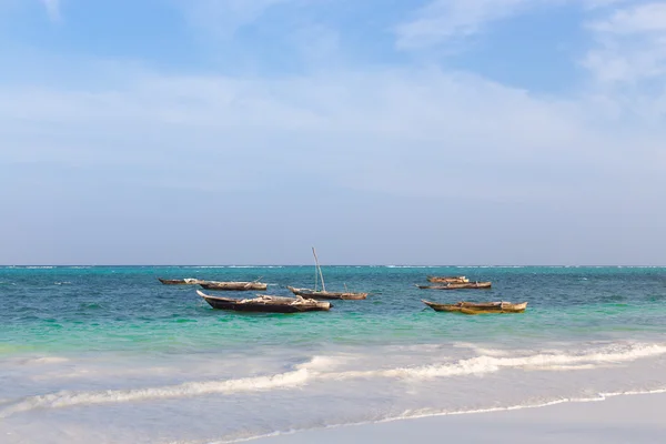 Wooden fishing boat in the ocean surf