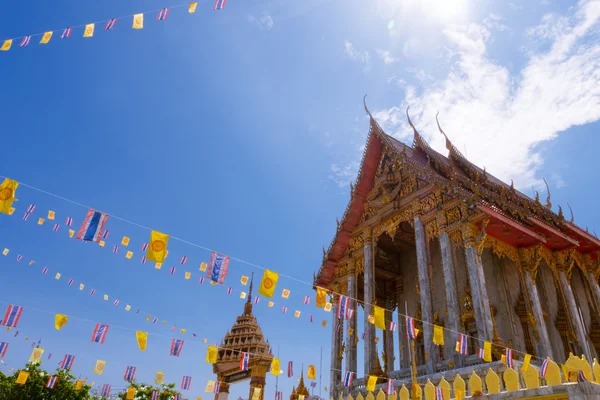 Samutprakarn, Thailand - July 19: Thai Buddhist decorate temple with Thailand flag and yellow Buddhism symbol flag to celebrating on Asalha Puja day or Asalha bucha Day before Khao Phansa day.