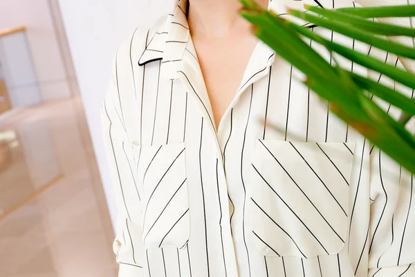 Beautiful white striped woman blouse shirt fashion details close up. minimal comfortable trendy fashion style.