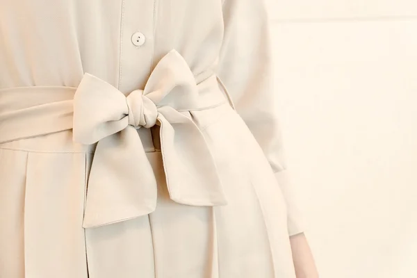 Details of bow belt tie in beige woman dress outfit style. trendy fashion.