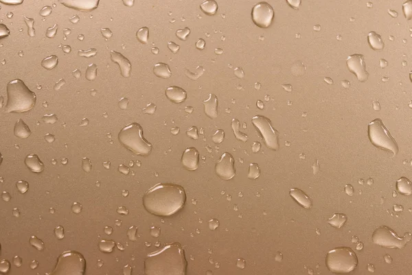 Drops of water on the car after rain - Gold car - Water drops on gold metal texture - Drops of water texture for background