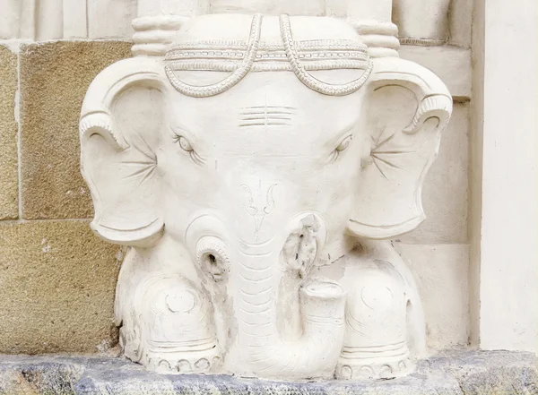 A sculpture of an elephant\'s head at the foot of one of the ancient temples. South India.