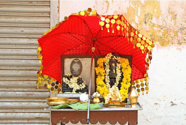 Puja for the gods from the shopkeeper. South India