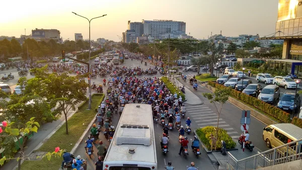 Traffic jam at evening rush hour while sunset. Streets are filled with an uncountable number of motorbikes, cars, bus and trucks in Ho-Chi-Minh-City