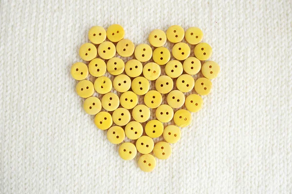 Yellow buttons in the form of heart