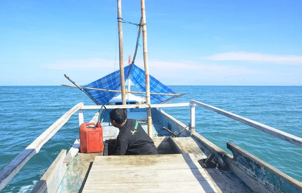Bawean Island, Gresik, East Java, Indonesia. March 29 2014. Wooden motor boat in the middle of Java Sea