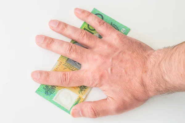 Man\'s hand on Australian Dollar banknote