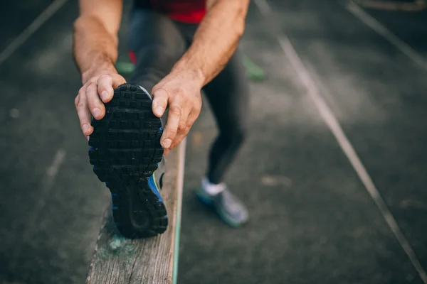 Male stretching before workout