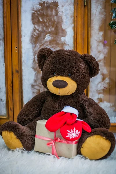 Teddy bear with a gift box near