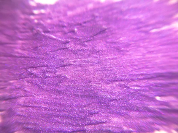Abstract violet shiny background, smeared nail polish
