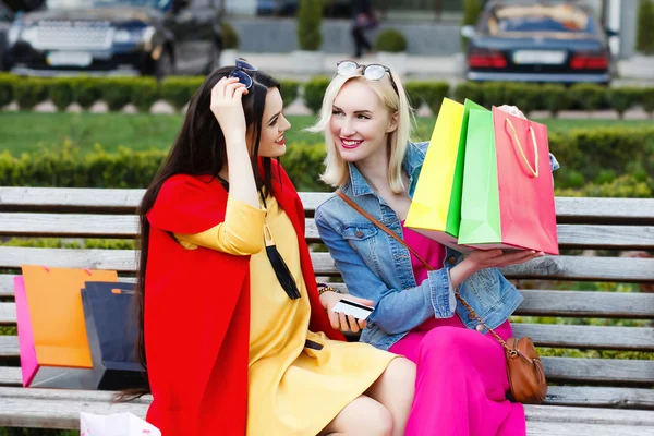 Happy people concept - beautiful women with shopping bags